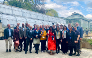 Attendees of the Biodiversity Heritage Library annual meeting pose for a group photo in front of the greenhouses in Jardin des Plantes